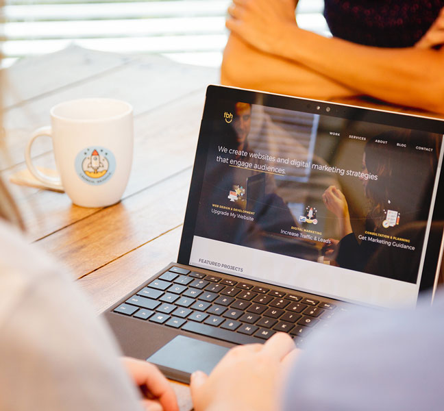 Marketing professionals collaborating over laptop