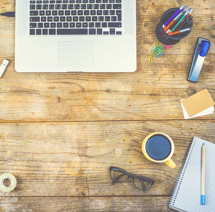 aerial view of desk with office supplies