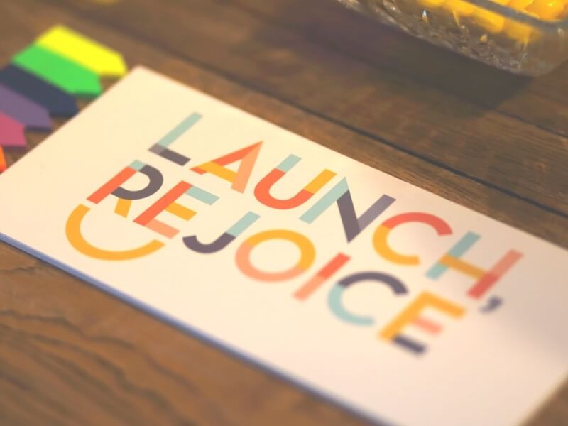 Printed card reading 'Launch, Rejoice'