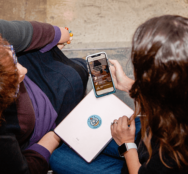 Two people viewing a website on a mobile device