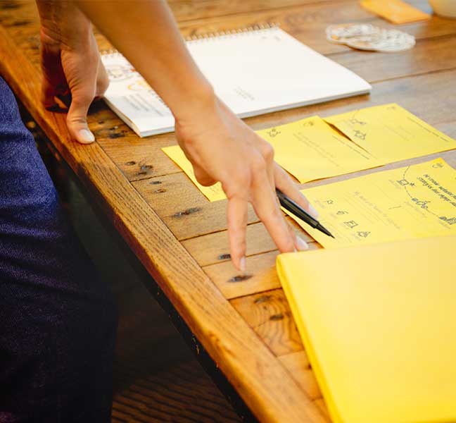 close-up of TBH team strategizing at table