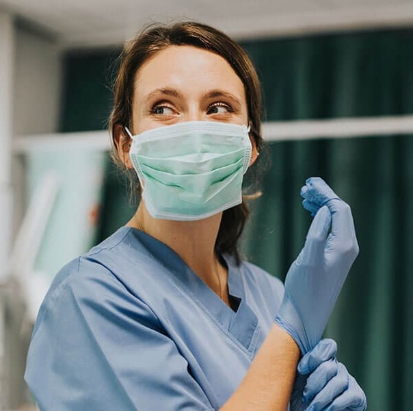 Nurse in surgical mask and gloves
