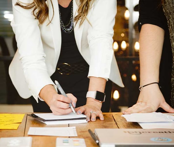 TBH team member taking notes in a strategy meeting