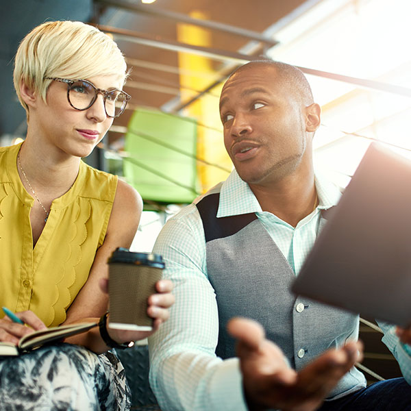 Coworkers on tablet in meeting