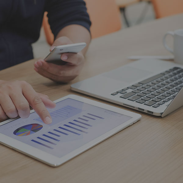 Using tablet and smart phone with laptop on desk