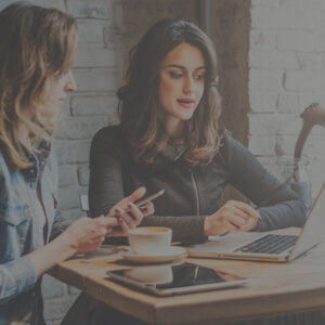 Coworkers looking at a computer in a meeting