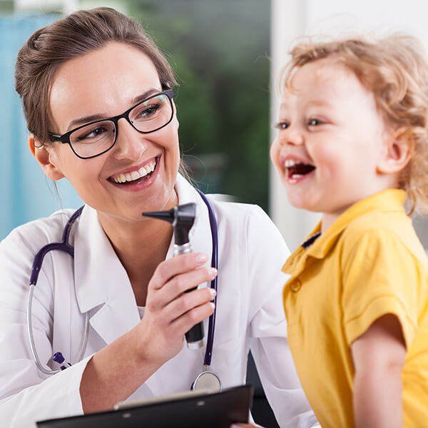 A pediatric doctor with a child during a checkup exam
