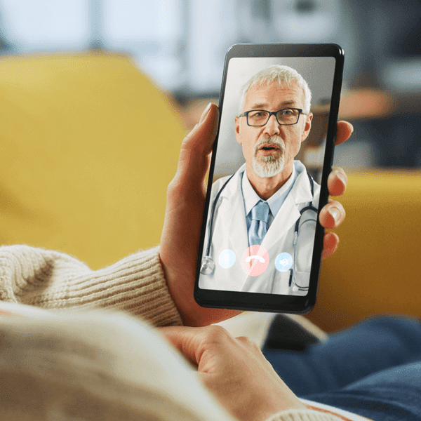 a patient talking to her healthcare provider using her mobile phone