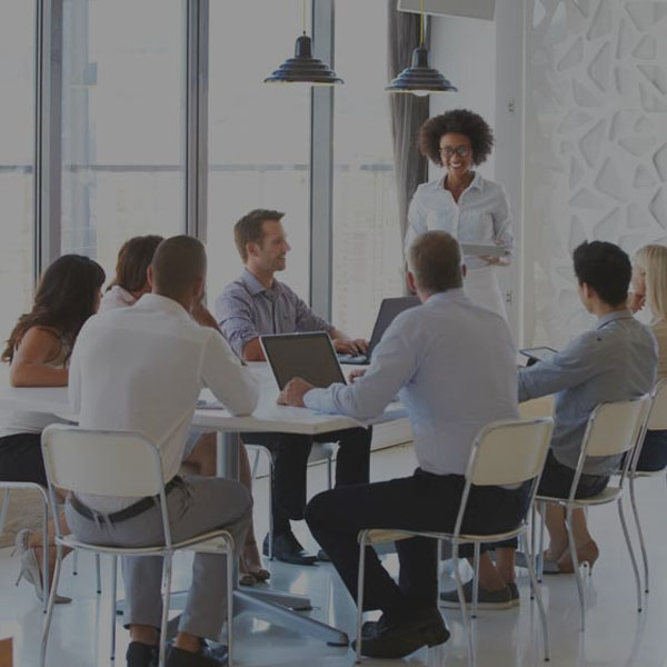 marketing professionals sitting at a table in a meeting