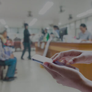 Patient using smartphone in hospital waiting room