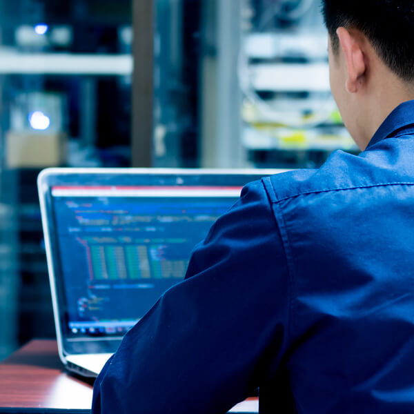 software developer working on multiple screens