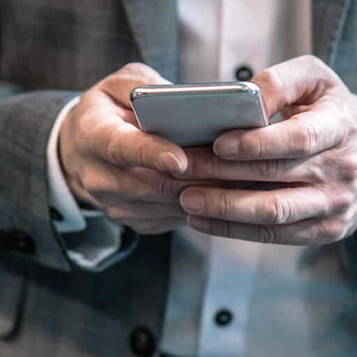 man in a business suit viewing using a mobile device