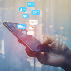 marketer uses his phone while trying to increase social media engagement for his company on Facebook