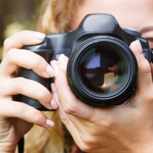 woman uses a camera to take branded marketing photos