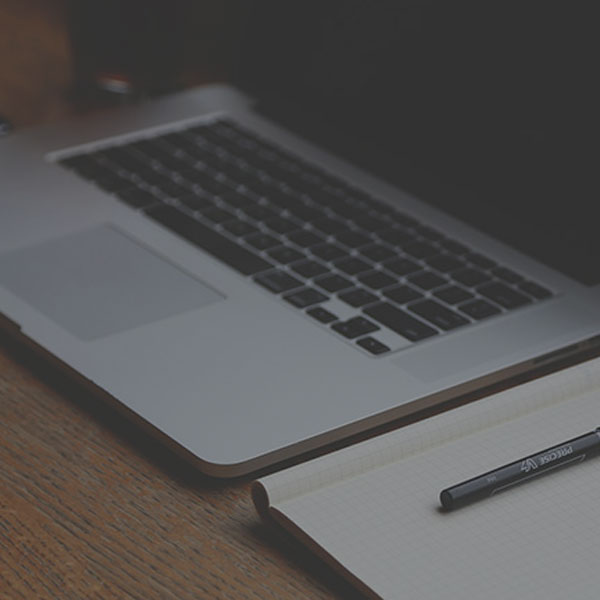 Planning with computer and notepad on desk