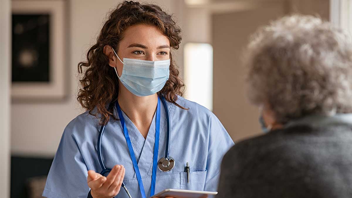 Nurse assisting elderly woman to create an egaging patient experience