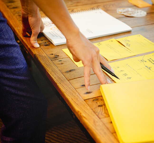 Person over-looking desk of strategy notes