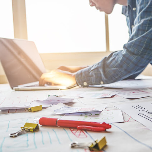 a graphic designer works on the layout of a website pricing page