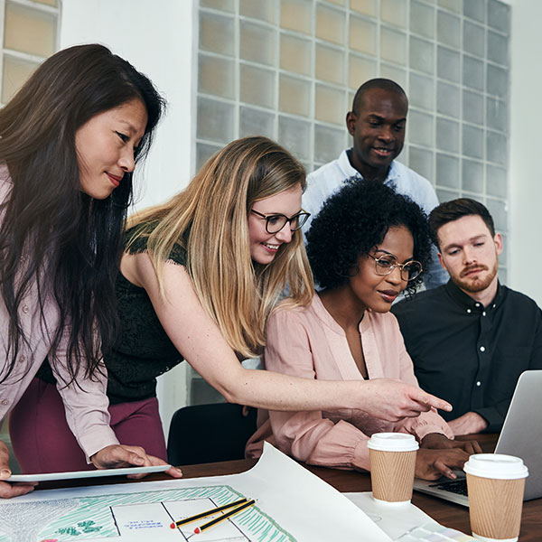 Marketing team collaborating on computer