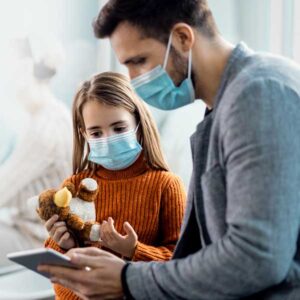 dad with his daughter in a doctor's office