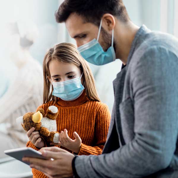 dad with his daughter in a doctor's office