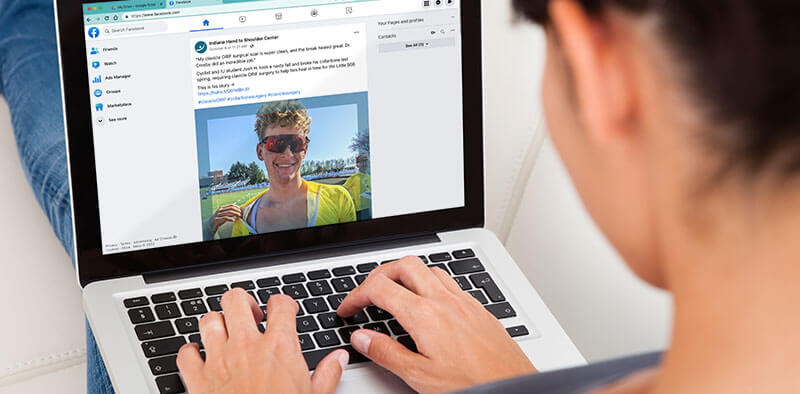 Woman looks at a healthcare social media post added to the IHTSC Facebook account