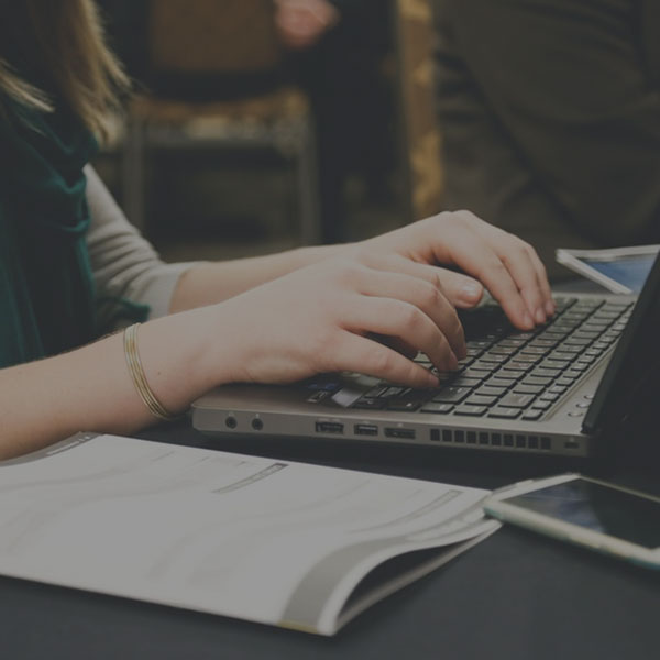 Woman at a desk working on a blog article