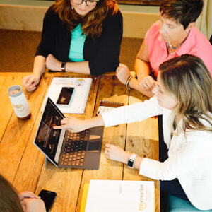 sitting at table with web design agency