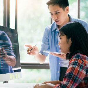 Digital marketing team collaborating on a website project around the computer