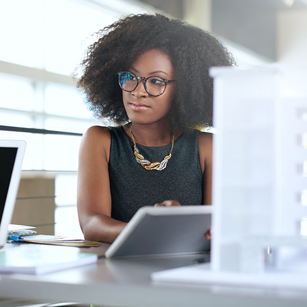 Business woman using a tablet to set smart website goals