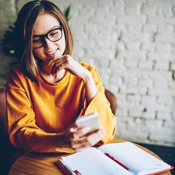 young woman browsing the web on her phone